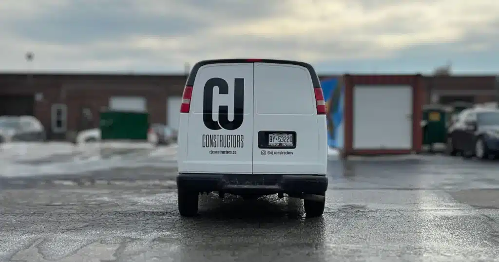Chevy Express van after the design and installation process of their van graphics. From the rear view. Instagram handle and website URL added to the design.
